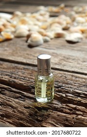 Perfume Bottle On A Wooden Background. Perfume With Woody Notes Concept.