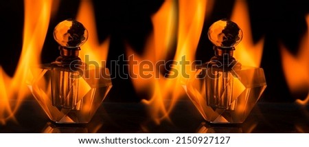 Perfume bottle surrounded by hot flames inside a campfire. Photography with special effect for commercial use.