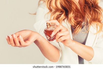 Perfume bottle woman spray aroma. Woman holding a perfumes bottle. Womans with perfum bottle. Beautiful girl using perfume. Woman with bottle of perfume.