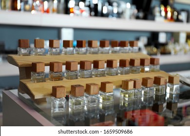 Perfume Bottles On Glass Counter In Shop