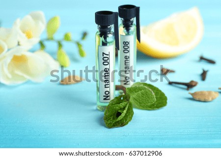 Perfume samples on color wooden  background