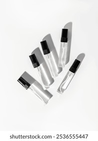 Perfume samples of small volume on white background. Miniatures of fragrances. Perfume for travel