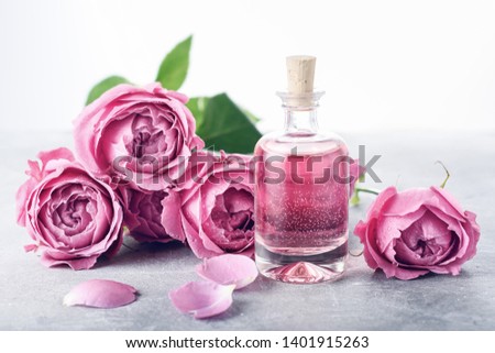 Perfumed Rose Water in glass bottle, roses.
