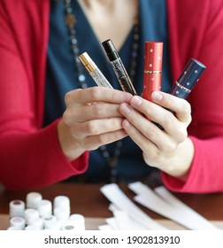 Perfumers Hands With Bottle Of Perfume With Blotter And Aroma Oil Close Up Photo