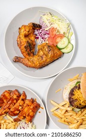 Peri Peri Chicken  Chips And A Cheeseburger  Potato Fries, Shot From Above