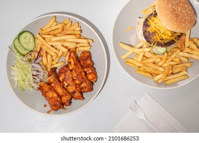 Peri Peri Chicken  Chips And A Cheeseburger  Potato Fries, Shot From Above