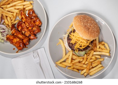 Peri Peri Chicken  Chips And A Cheeseburger  Potato Fries, Shot From Above