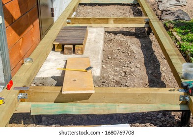 perimeter of the Foundation made of wooden beams on screw piles - Shutterstock ID 1680769708