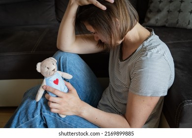 Perinatal loss reproductive chalenge concept - female holding a teddy bear toy - Shutterstock ID 2169899885
