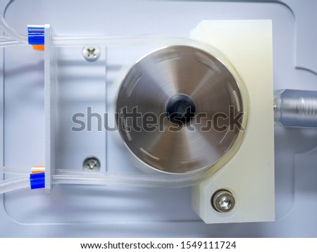 Peristaltic pump with plastic tubes. With rollers moving.