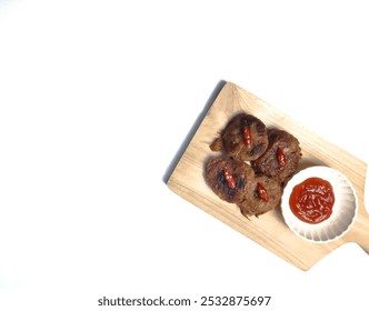 Perkedel, made of mashed potatoes and minced meat with sauce or chili paste (sambal). Indonesian fried patties - Powered by Shutterstock