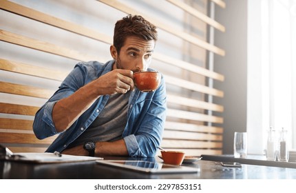 The perks of being the owner, free coffee. a handsome young man drinking coffee while working in a coffee shop. - Powered by Shutterstock