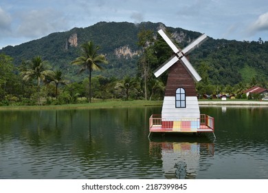 Perlis, Malaysia - August 07 2022: a replica of a windmill on the surface of the lake