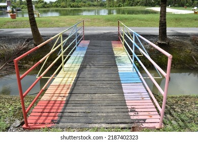 Perlis, Malaysia - August 07 2022: wooden bridge painted with a rainbow pattern