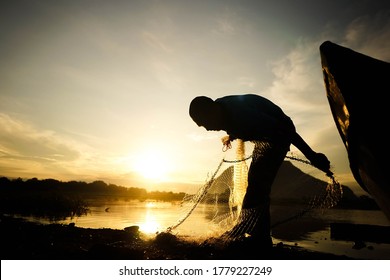 Perlis, Malaysia - July 17 2020 :   Hands Of Old Fisherman Checking Net. 