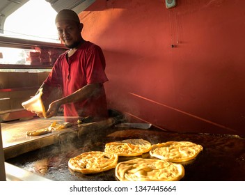 Perlis, Malaysia - March 22, 2019. A Man Making Roti Canai At His Small Shop At North Of Peninsular Malaysia.