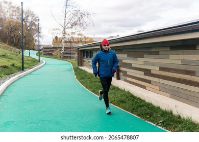 Perm, Russia - October 19, 2021: Man Jogging On All-weather Running Track In An Urban Environment

