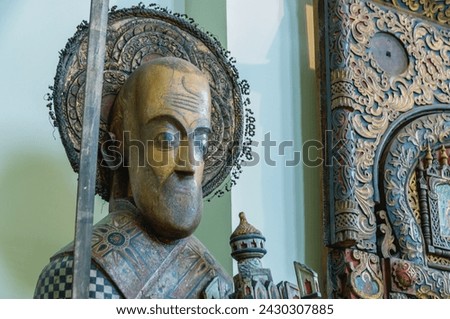 Perm wooden sculpture. A saint carved out of wood. Ancient sculptures in the church. The figure of a priest, carved from wood. Ancient masterpieces of wooden architecture. Religion and faith.