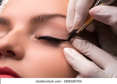 Permanent Eye Makeup Close Up Shot. Cosmetologist Applying Tattooing Of Eyes. Makeup Eyeliner Procedure