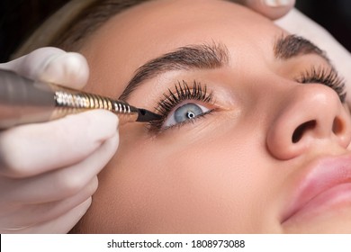 Permanent Eye Makeup Close Up Shot. Cosmetologist Applying Tattooing Of Eyes. Makeup Eyeliner Procedure