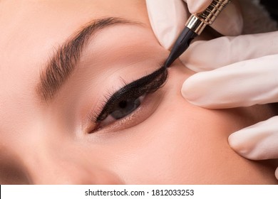 Permanent Eye Makeup Close Up Shot. Cosmetologist Applying Tattooing Of Eyes. Makeup Eyeliner Procedure