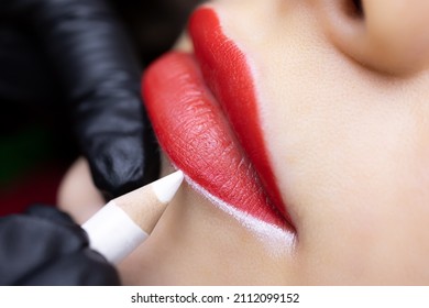 permanent lip tattoo procedure close-up of the model's lips preparation for the tattoo procedure outlined contours with a white pencil - Shutterstock ID 2112099152