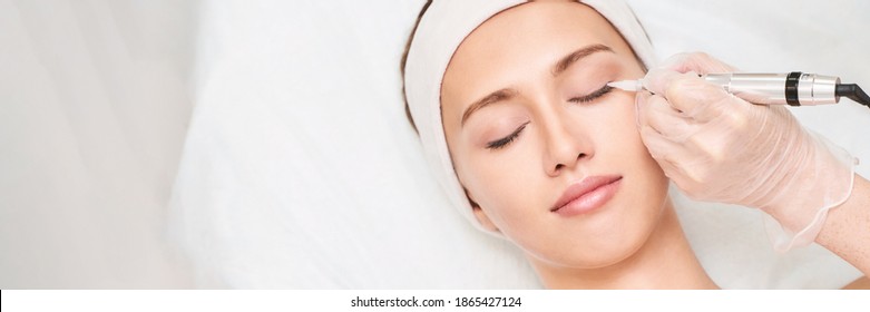 Permanent makeup. Beauty spa procedure. Beauty young woman. High quality photo. Eye tattoo. Eyeliner micropigmentation. Professional face microblading. Female cosmetology device. - Shutterstock ID 1865427124