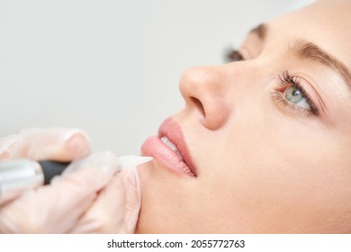 Permanent makeup. Beauty spa procedure. Beauty young woman. Lip tattoo. Liner micropigmentation. Professional face microblading. Female cosmetology device. - Powered by Shutterstock