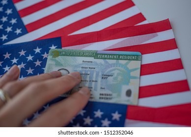Permanent Resident Green card  of United states of America on flag of USA. Above close up view.  - Shutterstock ID 1512352046