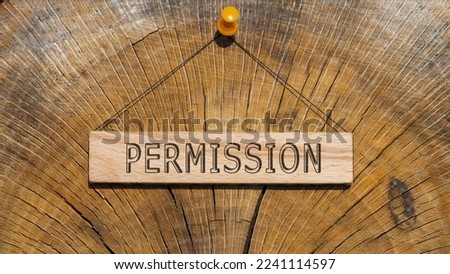 Permission word. Background log written on wooden board.