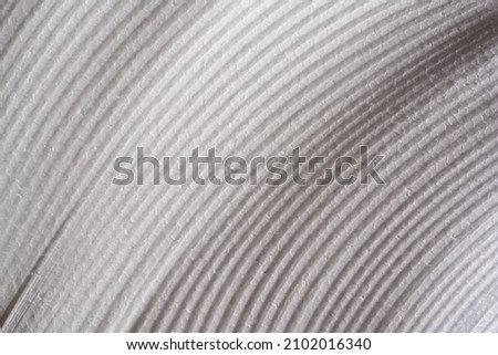 perpendicular view of a white polystyrene surface cut in half with an electrified wire with a battery