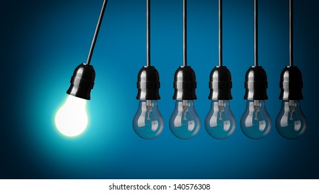 Perpetual motion with light bulbs. Idea concept on blue background. - Shutterstock ID 140576308