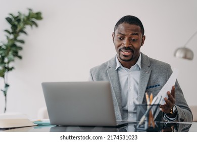 Perplexed african american male worker looking at laptop screen received dismissal notice. Puzzled black guy businessman reading bad news in email or having problem with computer. - Shutterstock ID 2174531023