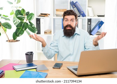 Perplexed guy making helpless gesture working at office desk, perplexity - Shutterstock ID 2117394134