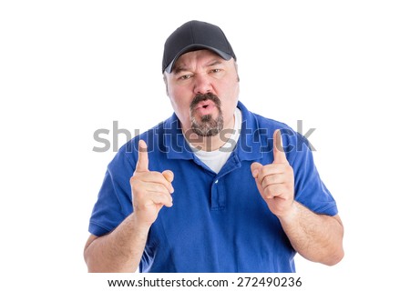 Perplexed man pointing upwards with his fingers as he frowns at the camera with a puzzled quizzical expression requiring an explanation, isolated on white