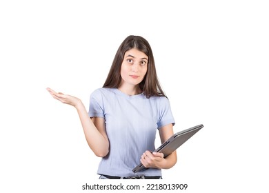 Perplexed Young Woman Shrugging Shoulders As Holds A Defect Laptop In Her Hand, Looking Confused To Camera Isolated On White Background