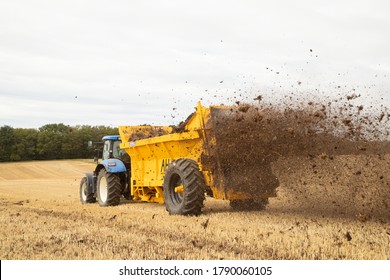 Perry Green, Much Hadham, Hertfordshire. England. UK. August 4th 2020. Farmer Driving A Tractor With A Muck Spreader Spreading Manure On A Field.