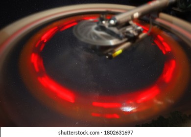 The Perseid Meteor Shower Can Be Seen In The Starry Sky. In The Foreground Is A Red Circle Of Light