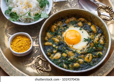 Persian breakfast with eggs, bean and dill in copper pan