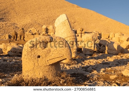 Persian eagle and apollo statues of Mount Nemrut at sunset.