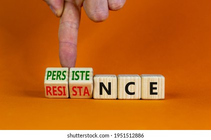 Persistence or resistance symbol. Businessman turns cubes, changes the word 'resistance' to 'persistence'. Beautiful orange background. Copy space. Business and persistence or resistance concept.