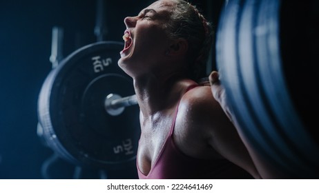 A Persistent Female Bodybuilder Enduring the Workout Pain of Exercising. Portrait of a Woman Challenging Gender Stereotypes And Lifting Heavy Weights and Training with a Barbell