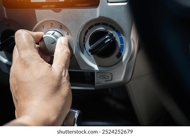 person is adjusting the temperature inside the car as the temperature outside soars to extreme levels.