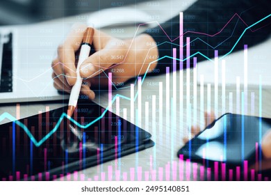 A person analyzing financial data on a tablet with a pen, with overlayed graphs and charts on a blurred background. Concept of online trading and market analysis - Powered by Shutterstock