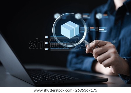 Person analyzing inventory data on a laptop with a digital magnifying glass highlighting a product box icon, symbolizing stock tracking, warehouse management, and inventory alerts.