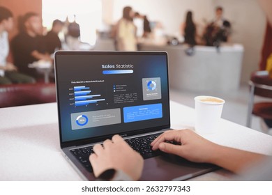Person analyzing sales dashboard on laptop showing monthly product performance, market analysis, and new customer statistics with coffee in background at modern cafe. - Powered by Shutterstock - Get 15% off with code: PIKWIZARD15