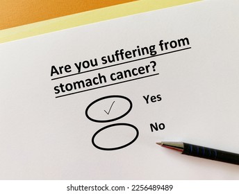 A person is answering question about illness. She is suffering from stomach cancer. - Shutterstock ID 2256489489