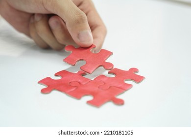 Person Assembling Puzzles Or Working To Find Solution Of Success To His Business. Person Completing Puzzles, Finding Answer, And Facing Challenges.