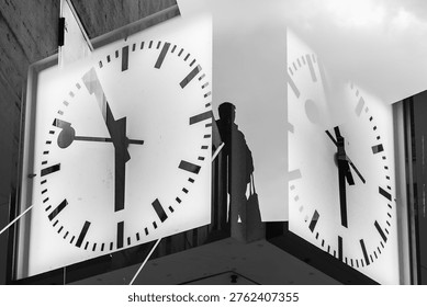 person between two clocks, double exposure