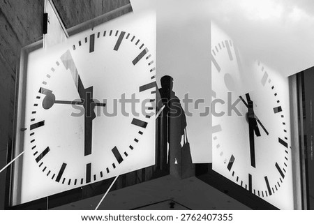 person between two clocks, double exposure
